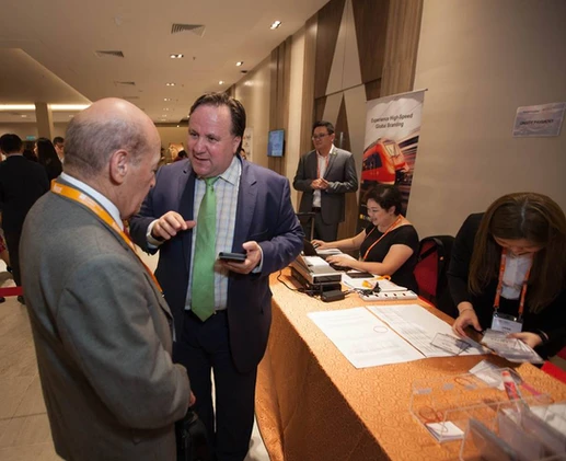 Dr. Cobanoglu at a conference registration desk